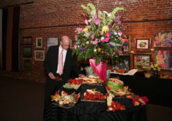 fruit and cheese table with large flower centerpiece