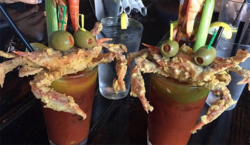 bloody mary topped with soft shell crab and olives