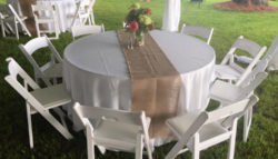 white chairs and table with burlap runner