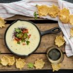 queso dip in cast iron pan