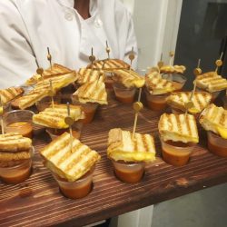 small cups of tomato soup topped with bite-size grilled cheese sandwiches