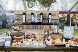 beautiful grazing table with cheeses, fruits and crackers