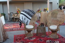 rattan chairs with black and white blanket at Moroccan-themed wedding